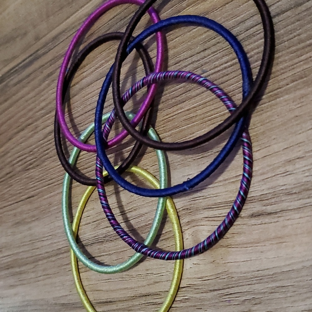 Various colored covered metal bracelets